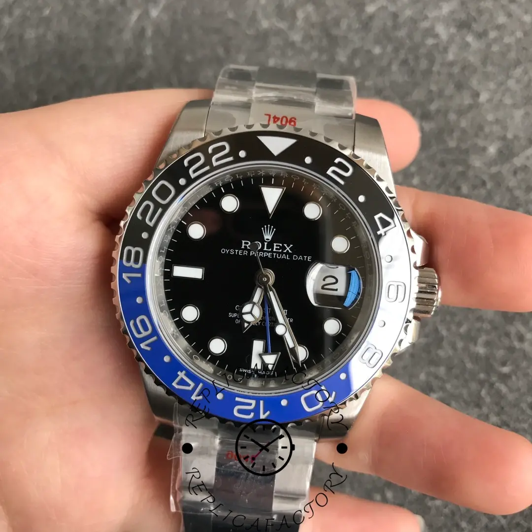 Hand-held front view of Rolex GMT-Master II 116710BLNR with Cyclops date window and GMT hand.
