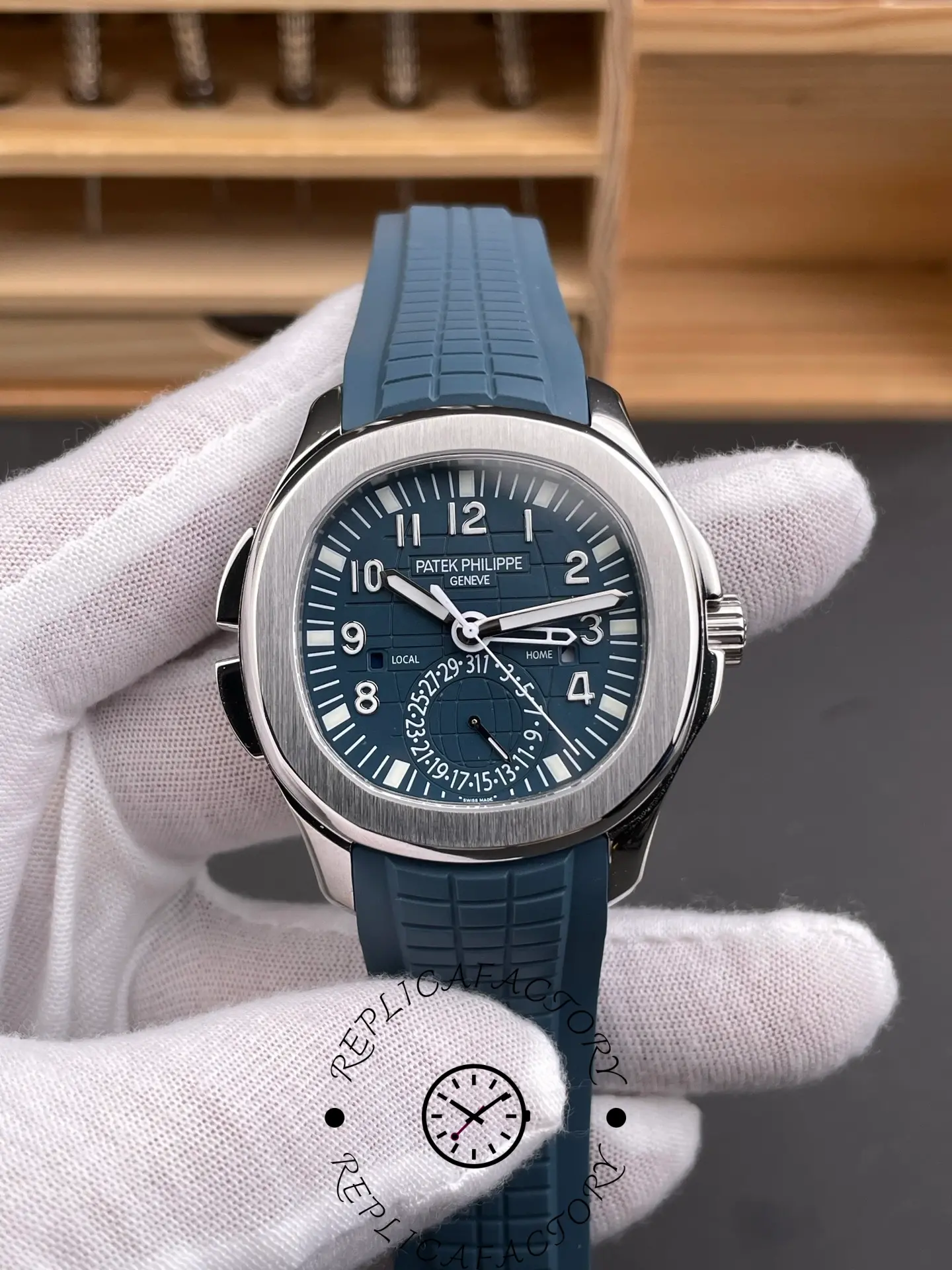 Front view of the Patek Philippe Aquanaut 5164G-001 showing blue dial, Arabic numerals and Travel Time display.