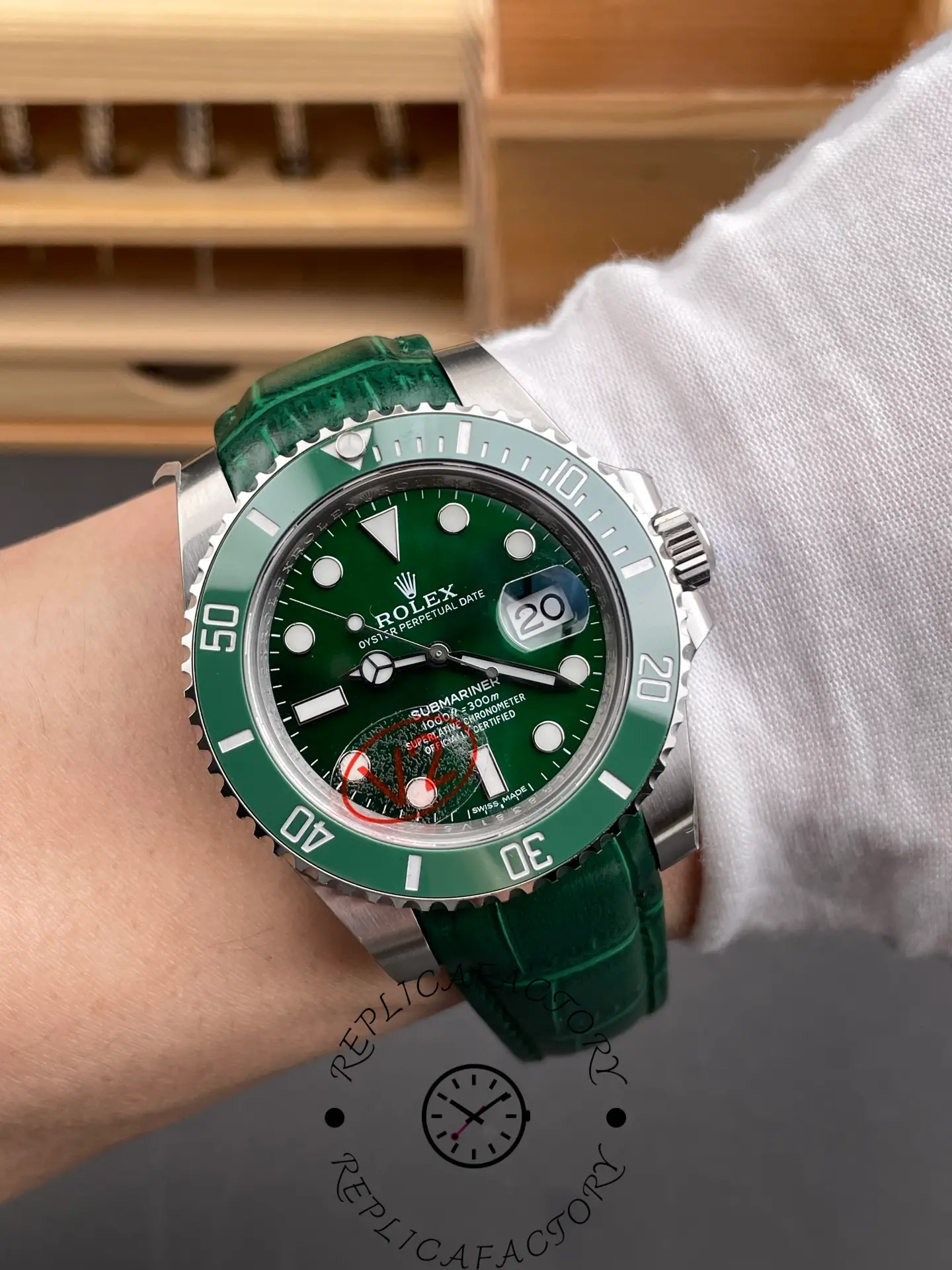 Rolex Submariner 116610LV, wrist shot showing green dial on green leather strap.