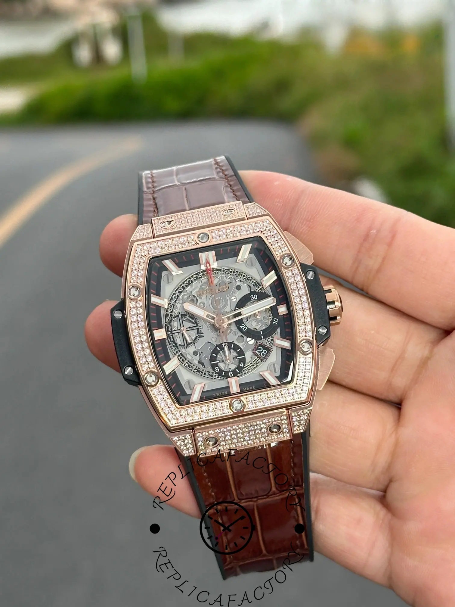 Handheld close-up of Hublot 641.OX.0183.LR.1704 highlighting leather strap texture.