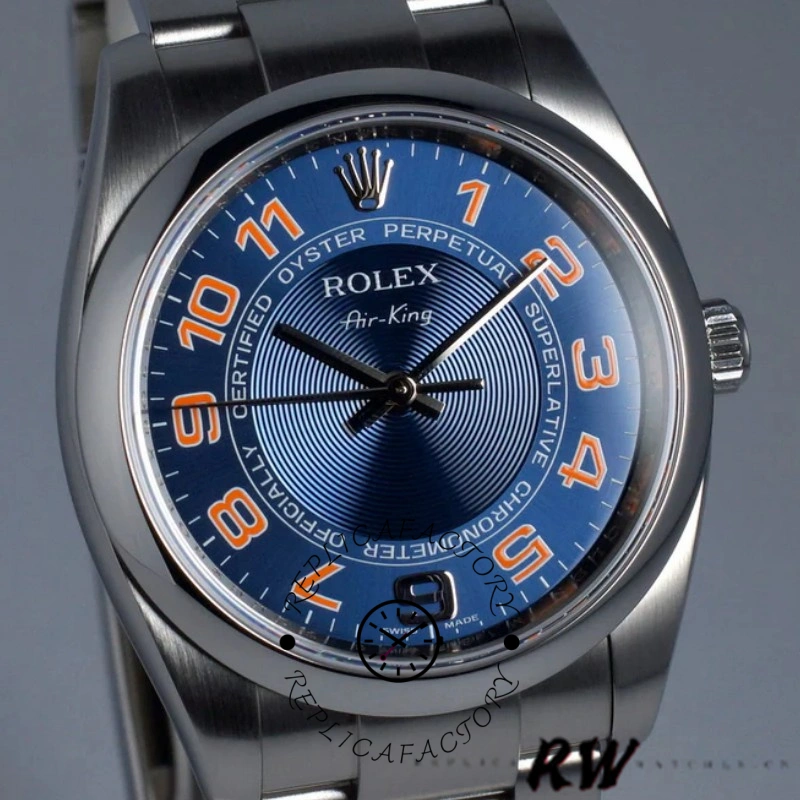 Rolex Air-King 114200, concentric blue dial close-up, orange numerals and hands.