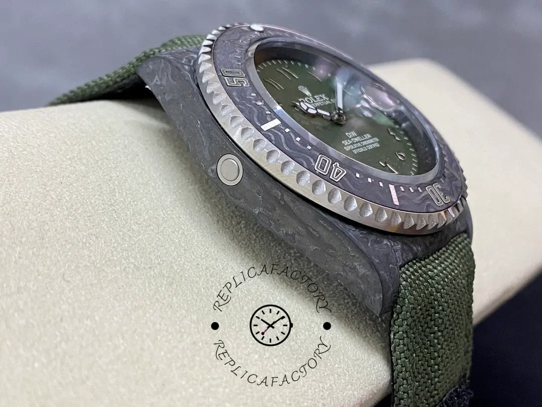 Rolex Sea-Dweller DiW Carbon HUNTER ARABIC side angle, carbon case thickness, green strap on cushion.