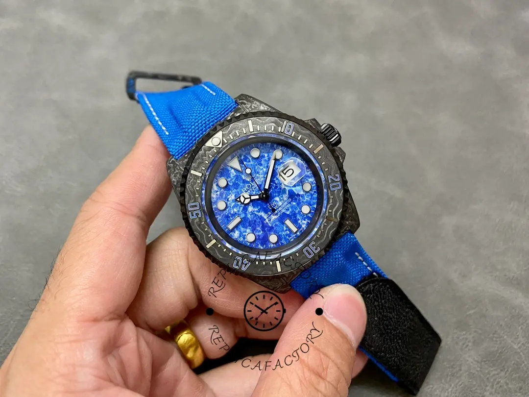 Rolex Sea-Dweller DiW Carbon Fiber, ocean blue dial, full watch in hand view.