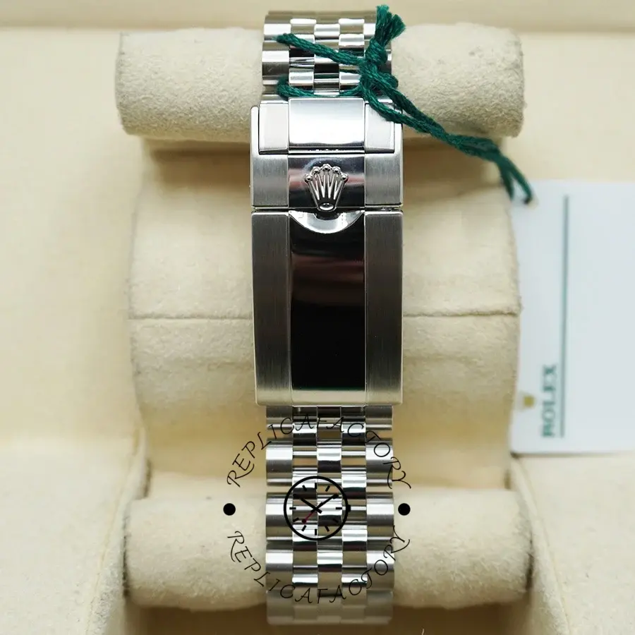 Rolex GMT-Master II M126710GRNR 0003, clasp top view on pillow with hangtag attached.