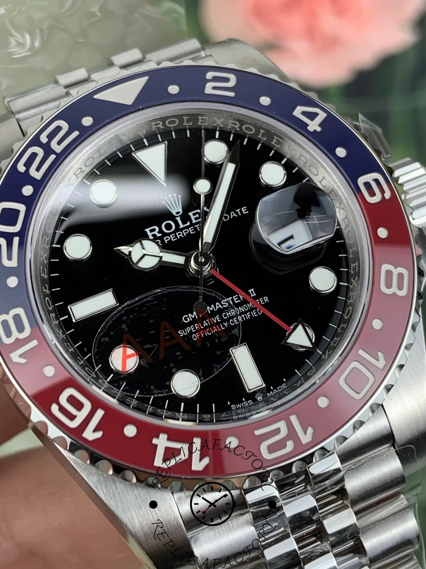 Macro shot of Rolex GMT-Master II 126710BLRO dial and Pepsi bezel, showing cyclops date magnifier.