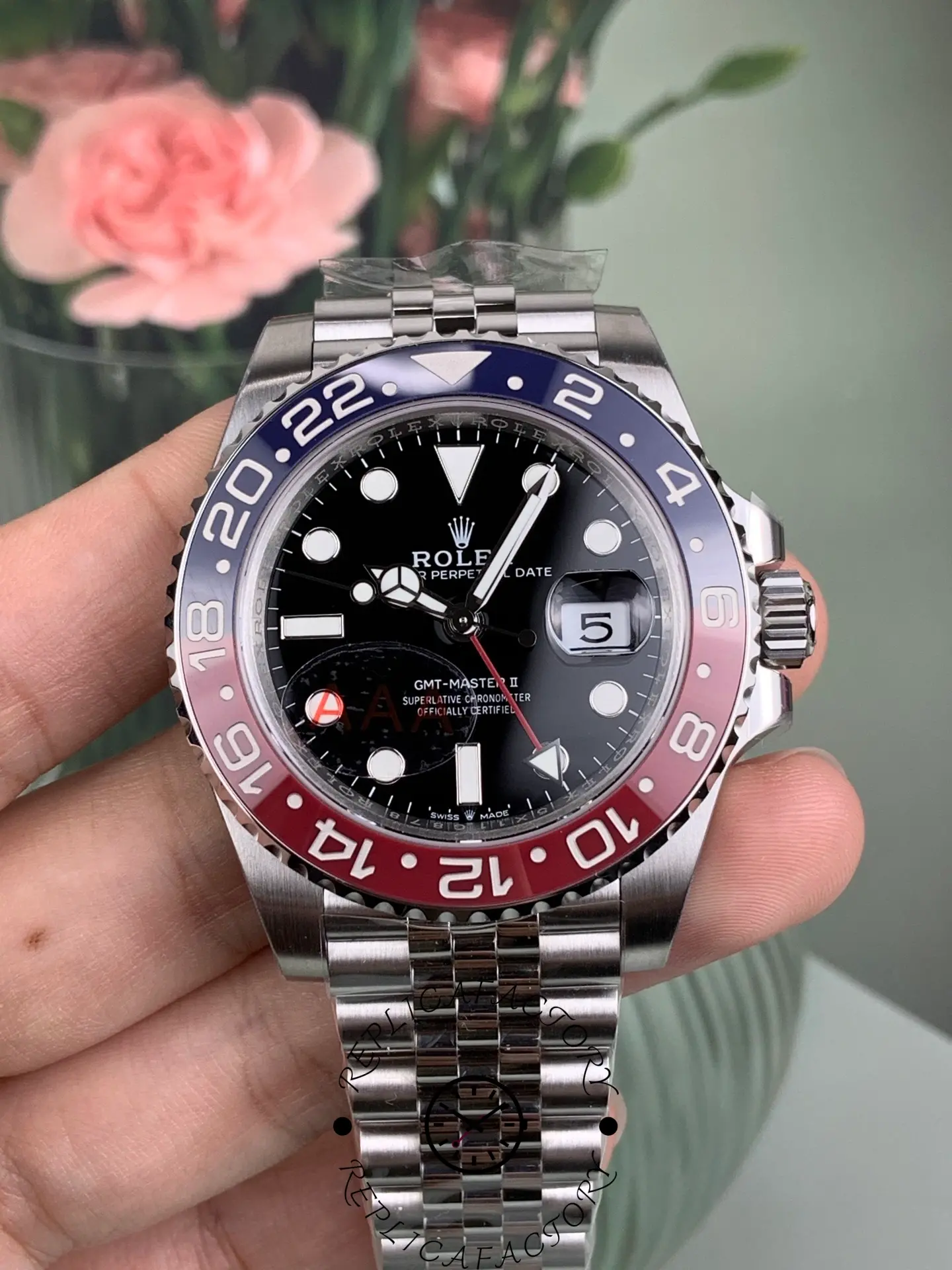 Close-up front view of Rolex GMT-Master II 126710BLRO showing Pepsi bezel, black dial and date window.