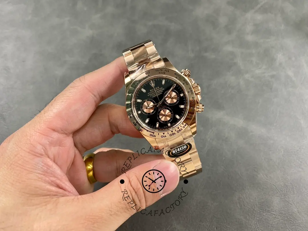 Handheld full view of Rolex Daytona 126505-0001 showing black dial and rose gold bracelet.