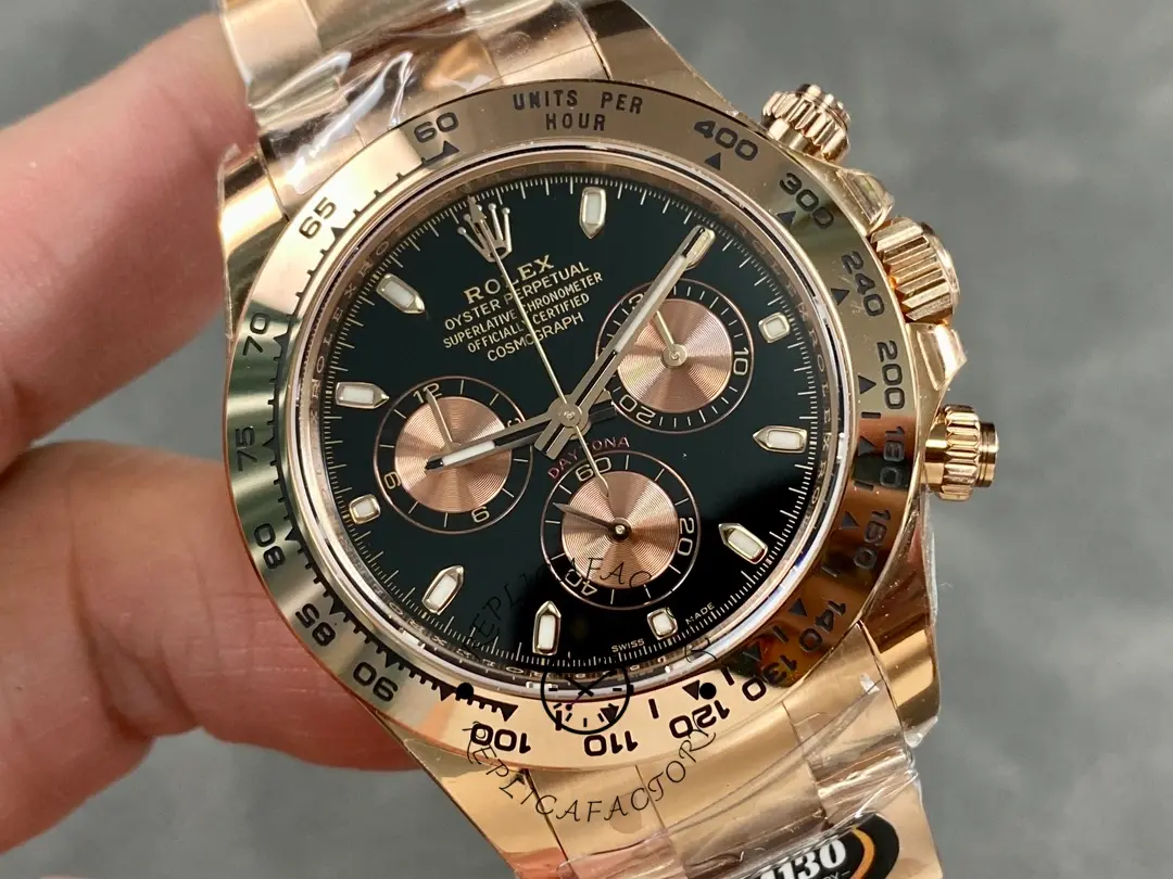 Handheld view of Rolex Daytona 126505-0001 showing black dial and rose gold bezel edge.