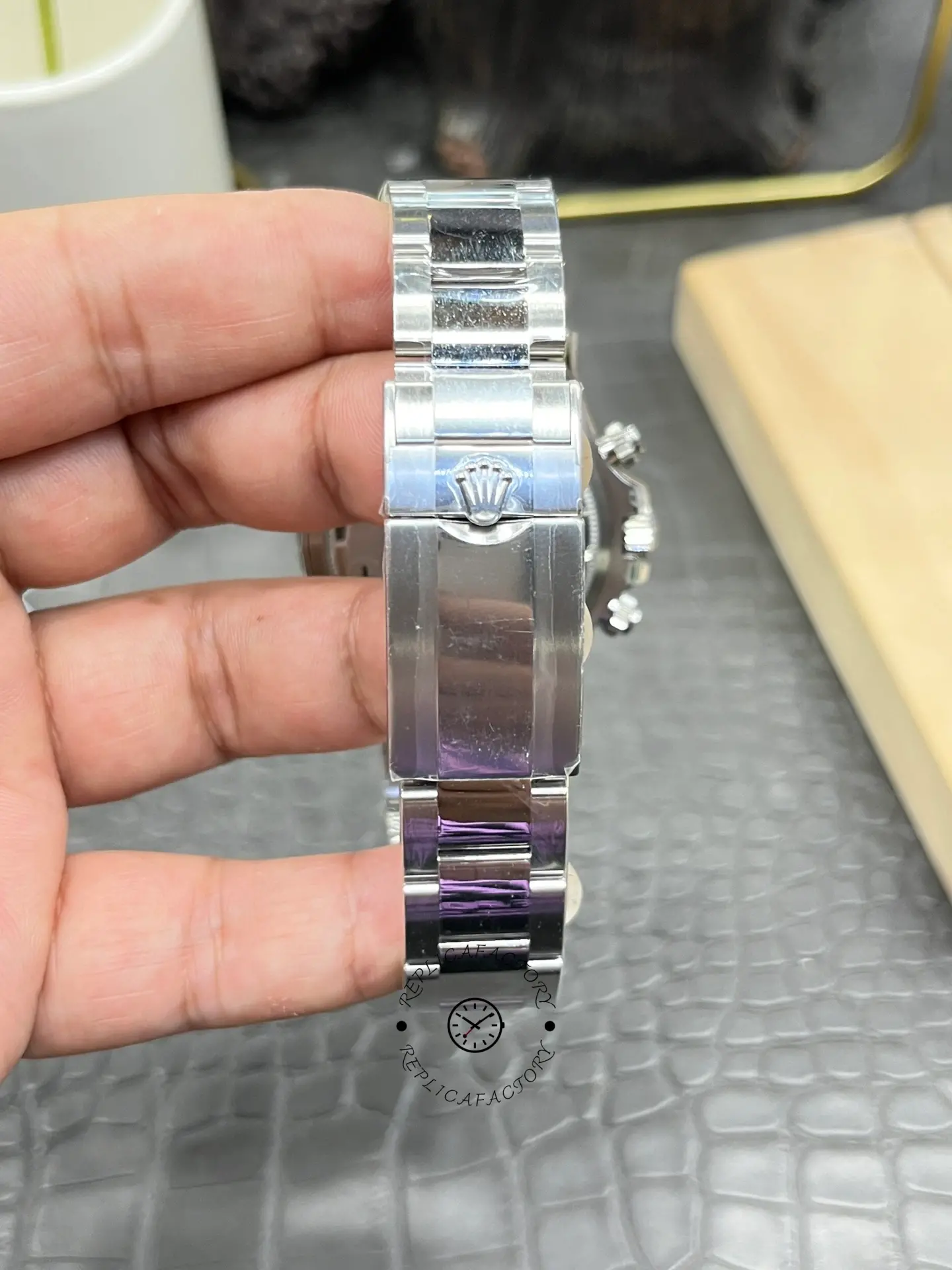 Rolex Daytona M126500LN-0001 bracelet close-up, clasp and links with protective film.