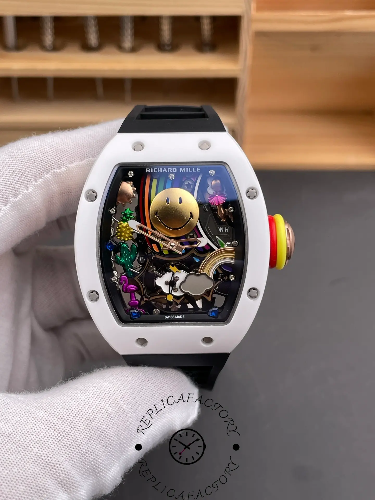 Hand-held front view of Richard Mille RM 88 replica with Smiley dial and colored crown rings on the right side.